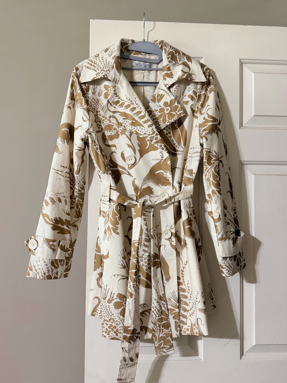 Woman’s CAbi Cream Trench Coat with Tan Botanical Print